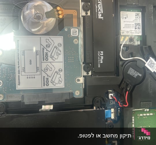 חלקים פנימיים של מחשב נייד עם כונן SSD ורכיבים נוספים